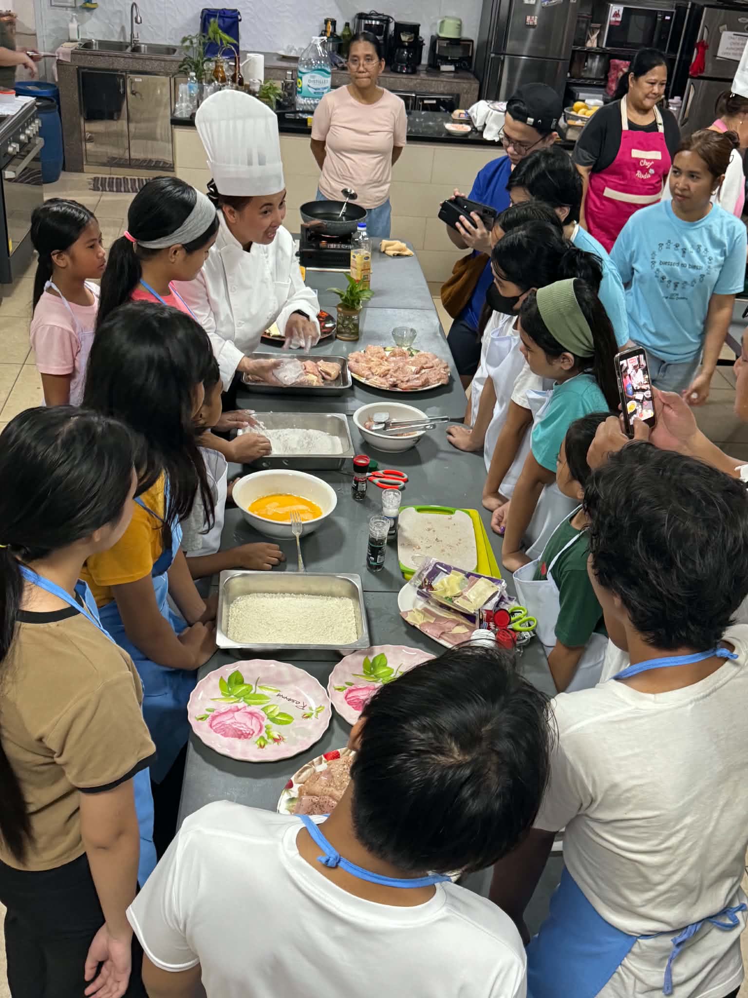 Sponsored students learning to cook during a free cooking class at YWAM Balut